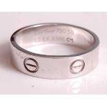 An 18ct white gold Cartier Love ring, width 5.85mm, signed Cartier, serial number EY8386, size U½,