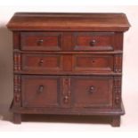 A Jacobean period oak chest of three long geometric moulded graduated drawers, having panel sides