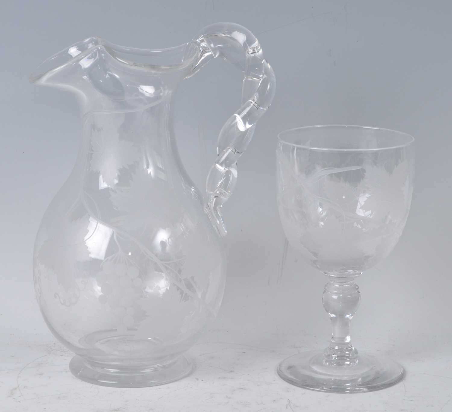 A Victorian glass wine jug, of baluster form with ropetwist handle, the whole acid etched with