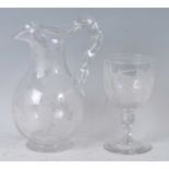 A Victorian glass wine jug, of baluster form with ropetwist handle, the whole acid etched with