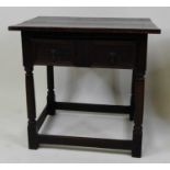 An early 18th century joined oak side table, having a two-plank top, geometric moulded single frieze