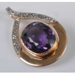 A yellow and white gold amethyst pendant, comprising a large oval amethyst in a bezel setting,