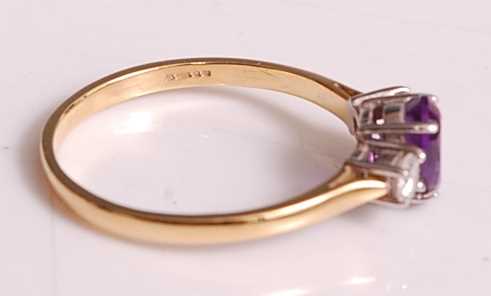 An 18ct yellow and white gold, amethyst and diamond three-stone ring, comprising a centre oval - Image 4 of 7