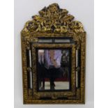 A 19th century continental ebonised and embossed brass wall mirror, in the Baroque taste, having a