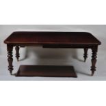 A Victorian mahogany extending dining table, the top having wind-out action, moulded edge, and two