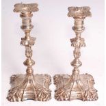 A pair of early George III cast silver tapersticks, of fluted and gadrooned baluster form to