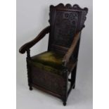An early 18th century joined oak Wainscot chair, the blind carved panelled back with a central