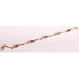 An 18ct yellow gold and amethyst bracelet, comprising five oval amethyst in bezel settings