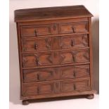 A Jacobean period oak chest, of five long geometric moulded drawers, each with steel teardrop