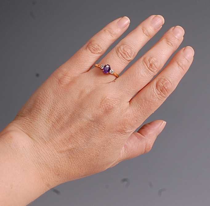 An 18ct yellow and white gold, amethyst and diamond three-stone ring, comprising a centre oval - Image 7 of 7