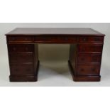 An early Victorian mahogany twin pedestal partner's desk, having a tooled leather inset writing