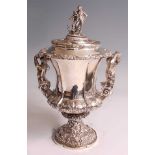 A William IV silver pedestal cup and cover, the cup of fluted campania form, chased and embossed