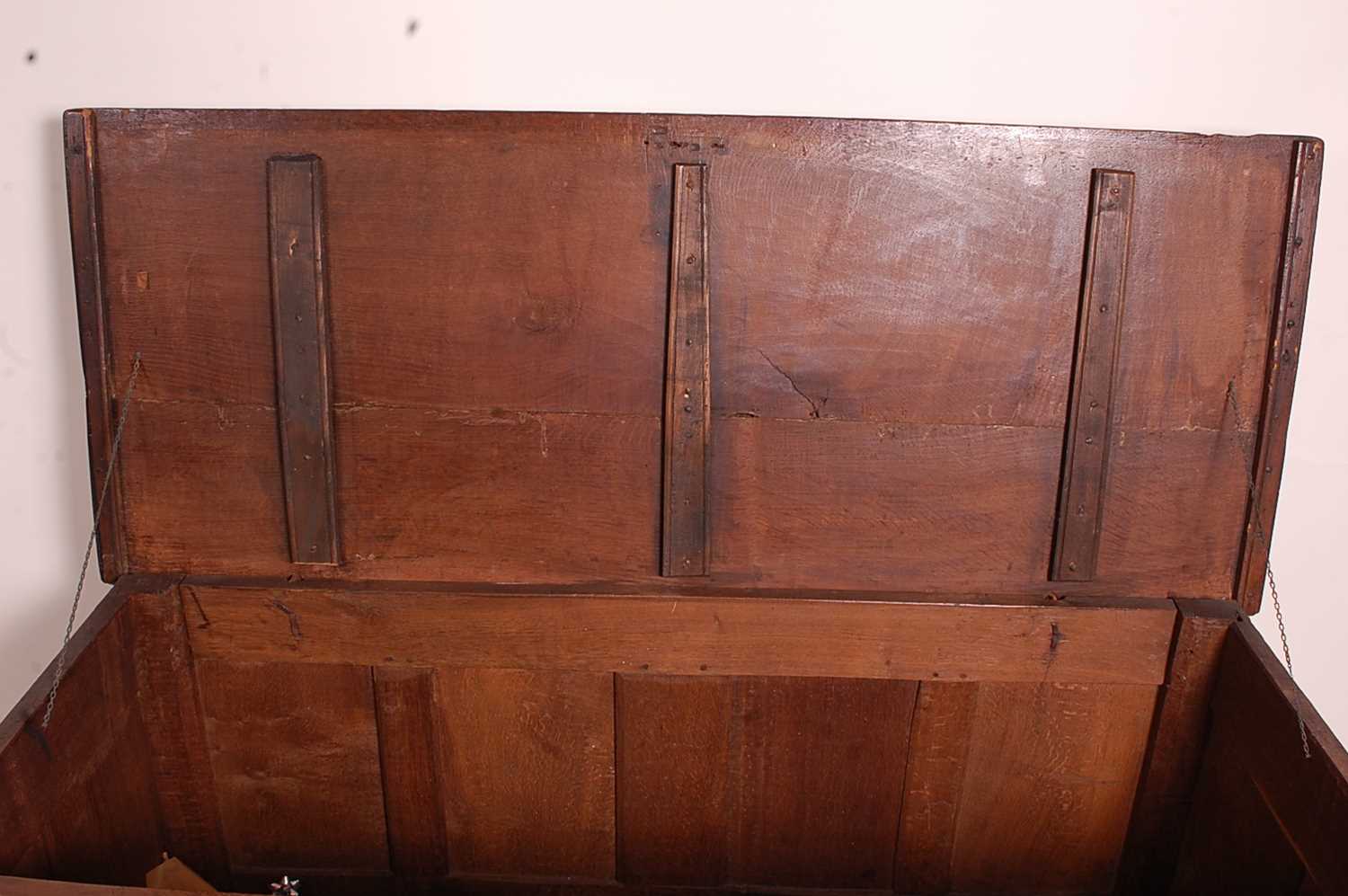 A circa 1700 joined oak four-panel coffer, the two plank top on original steel loop hinges, the - Image 4 of 7