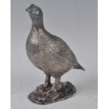 A modern silver and loaded model of a grouse in standing pose, maker Camelot Silverware Ltd, h.17cm