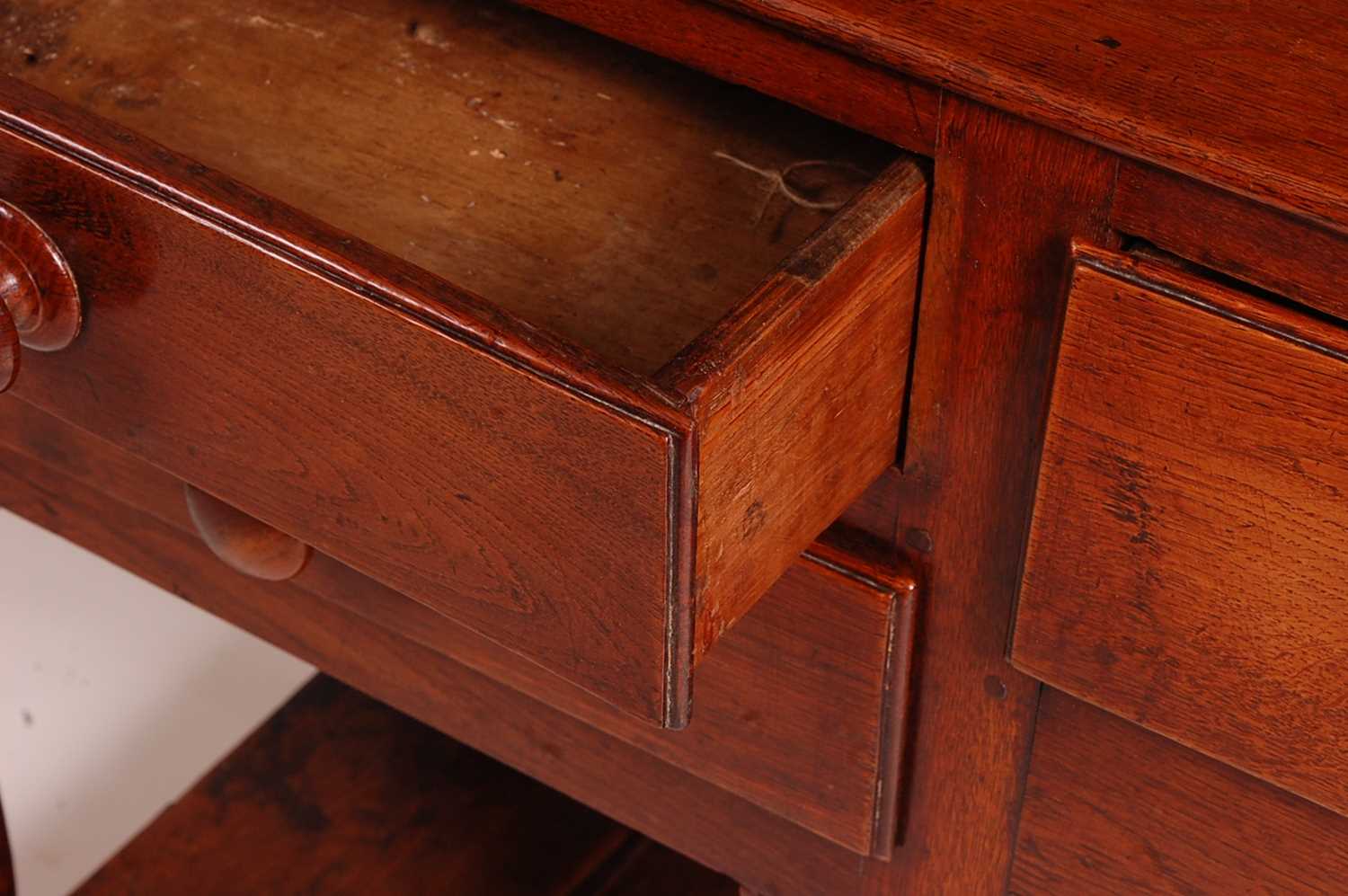 An 18th century oak dresser, the upper section having a two-tier plate rack with ironmongery to each - Image 3 of 13