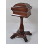 A William IV fiddleback mahogany pedestal teapoy, of sarcophagus outline, the hinged cover opening