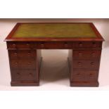 A Victorian oak twin pedestal desk, having a gilt tooled leather inset writing surface above three