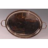 A George V silver twin handled oval tray, having a plain ground and gadrooned raised gallery,
