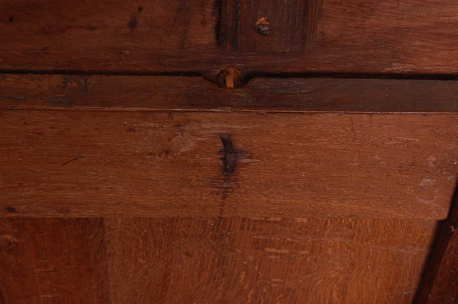 A circa 1700 joined oak four-panel coffer, the two plank top on original steel loop hinges, the - Image 5 of 7