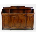 A Regency rosewood breakfront four-door bookcase, having a raised open upper section, the panelled