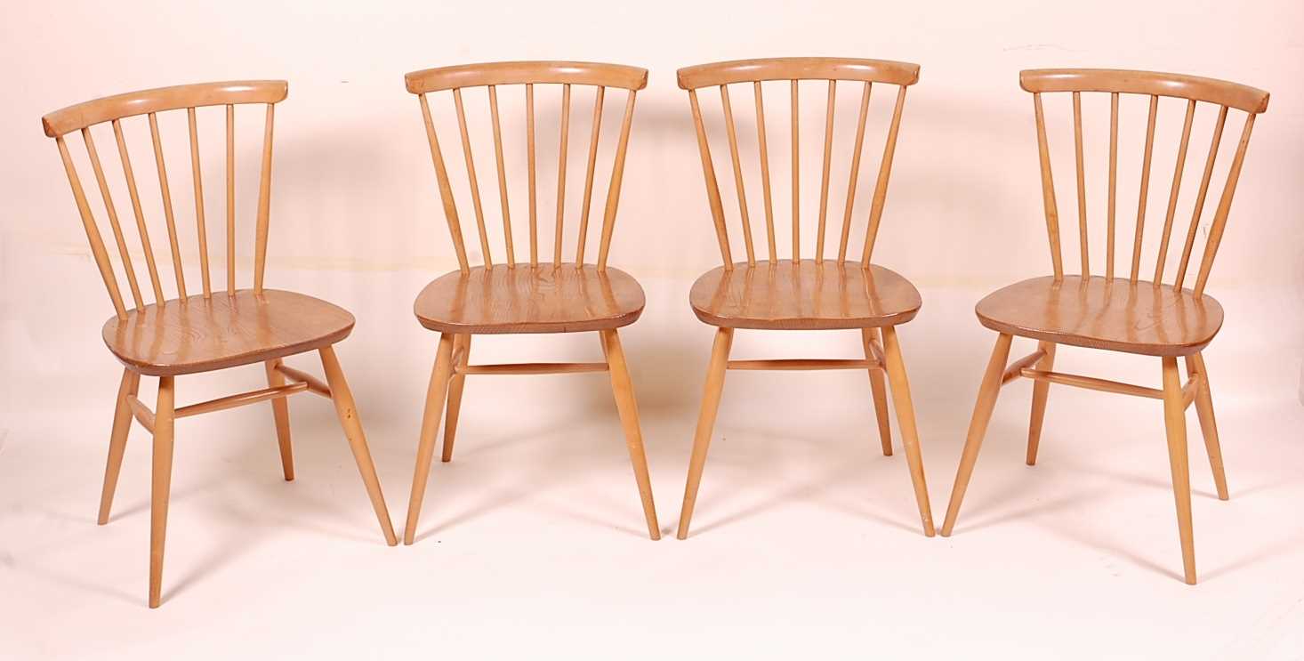 A set of four Ercol blond elm stickback kitchen chairs, each raised on typical turned supports, w.
