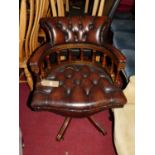 A contemporary mahogany tan leather buttoned and studded tub swivel desk chair, width 63cm