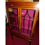 An Edwardian mahogany and satinwood inlaid double door glazed china display cabinet, having silk