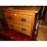 A 1920s oak low chest of two long drawers, on turned slightly tapering supports, w.75cm