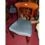 A set of four early Victorian mahogany balloon back dining chairs, each having blue upholstered