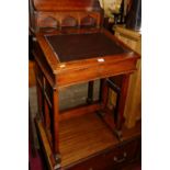 An unusual Arts & Crafts walnut davenport, having a raised superstructure, hinged rexine inset