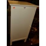 A contemporary white painted single door low bathroom cabinet, w.41cm