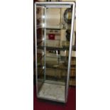 An anondised metal square glass inset display cabinet, of square form, having four interior shelves,