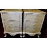 A pair of French white painted serpentine front three drawer bedside chests, on squat cabriole