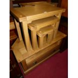 A contemporary light oak nest of three occasional tables, the largest w.65cm; together with a