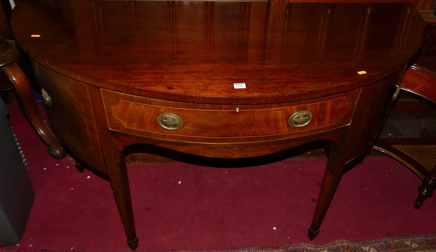 A 19th century mahogany demi-lune sideboard, having single central drawer flanked by cupboard doors,