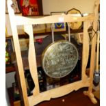 A light oak framed floor standing gong, having engraved brass plaque, with beater, w.54cm