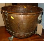 A late 19th century riveted copper circular log bucket raised on paw feet, dia 46cm