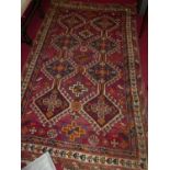 A Persian woollen red ground Bokhara rug, 225 x 144cmCondition report: Losses to extremities and