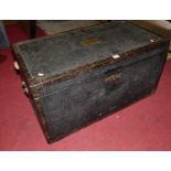 An early 20th century canvas and metal bound hinge-top travelling trunk, with lined interior and