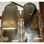 A pair of bevelled wall mirrors, each within swept gilt composition pilasters, full dimensions 110 x