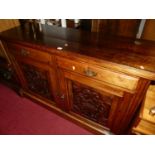 An Edwardian walnut double door side cupboard, having twin upper drawers, the panelled cupboard