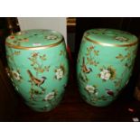 A pair of Chinese style floral and gilt painted stoneware barrel garden seats, of slightly ovoid