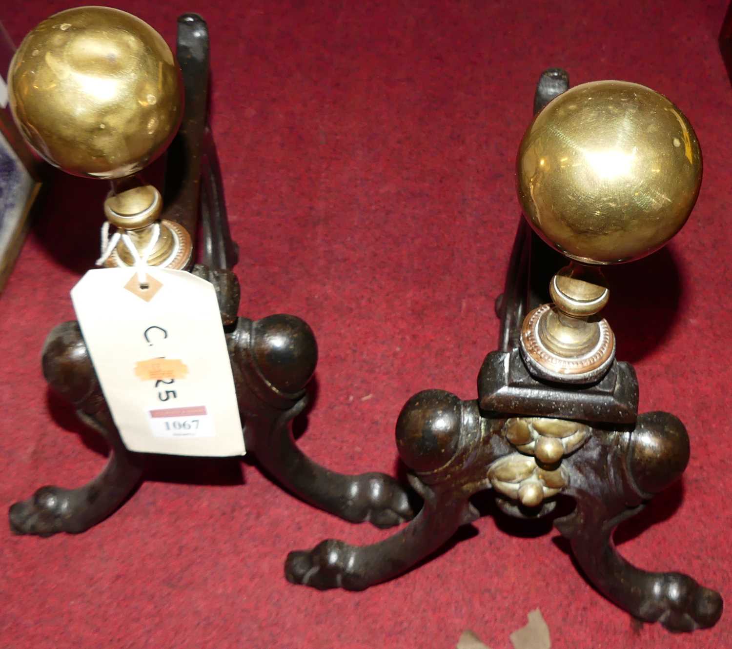 A pair of art nouveau influenced cast iron and brass fire dogs, height 37cm