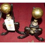 A pair of art nouveau influenced cast iron and brass fire dogs, height 37cm