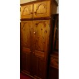 A modern pine double door wardrobe, having twin door upper section, width 99cm