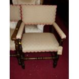 Two near matching pairs of joined oak floral upholstered and further studded elbow chairs, each in