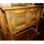 A contemporary Old Charm linenfold panelled oak low double door side cabinet, labelled to