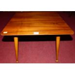 A 1960s plywood and walnut veneered low occasional table, raised on turned tapering supports, w.