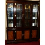A contemporary Chinese hardwood and elm breakfront display cabinet, having four bevelled glazed