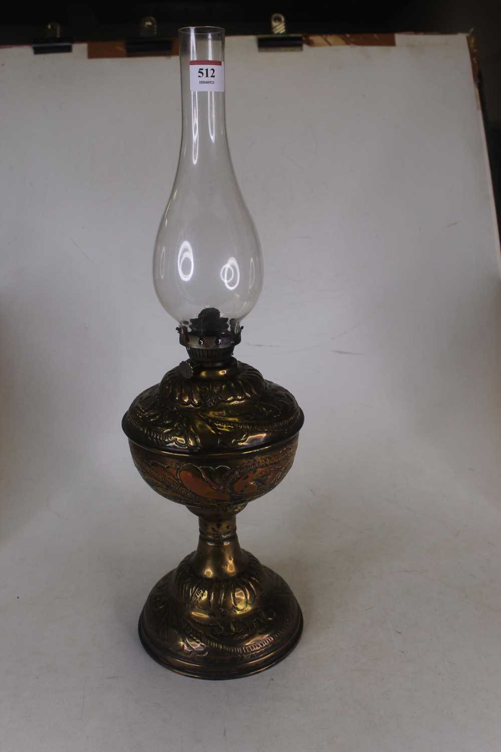 An Art Nouveau influenced embossed brass floral decorated oil lamp, with glass chimney, height 53. - Image 3 of 3